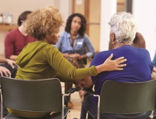 People attending self-help therapy group meeting in a community center.
