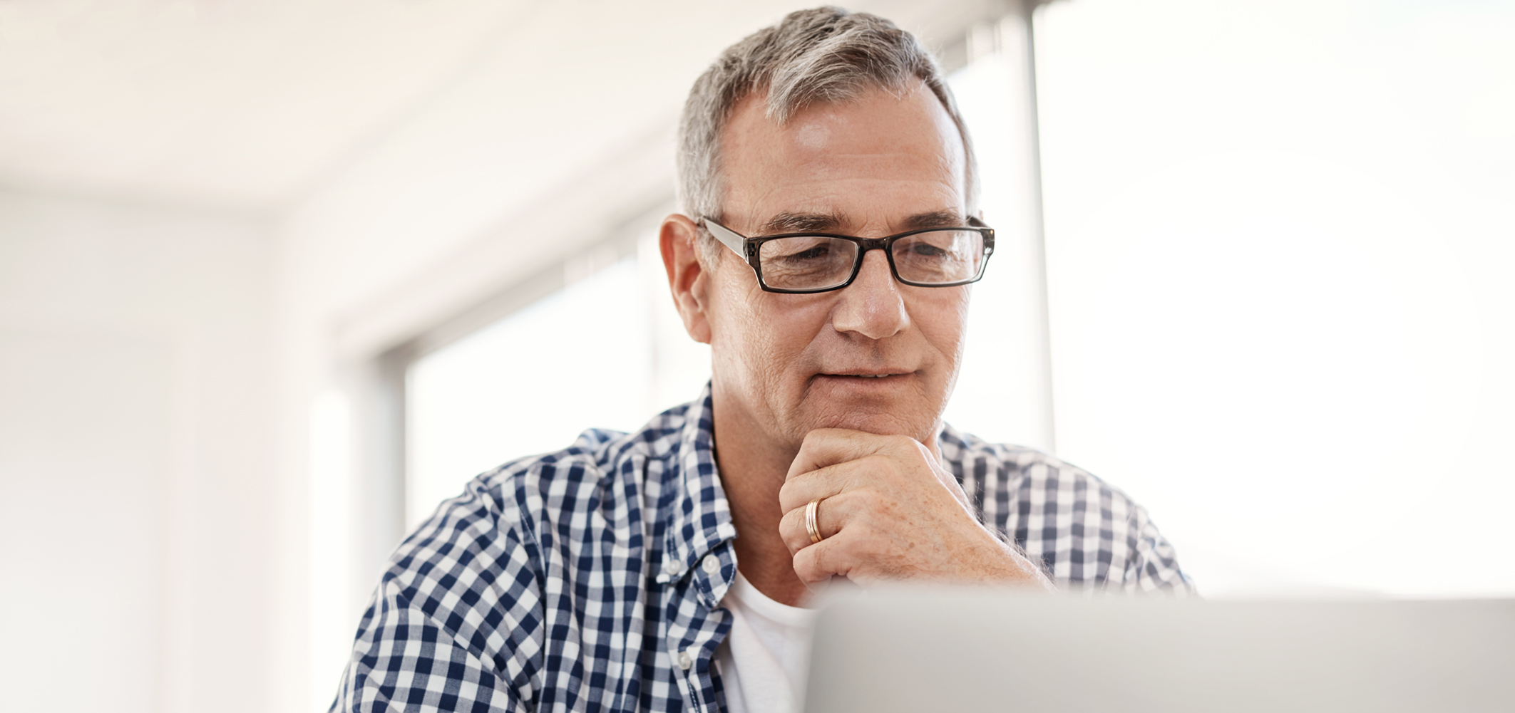Senior man sitting at a computer