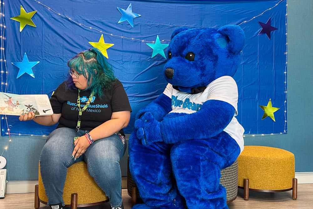 Woman and Blue Bear having storytime for children