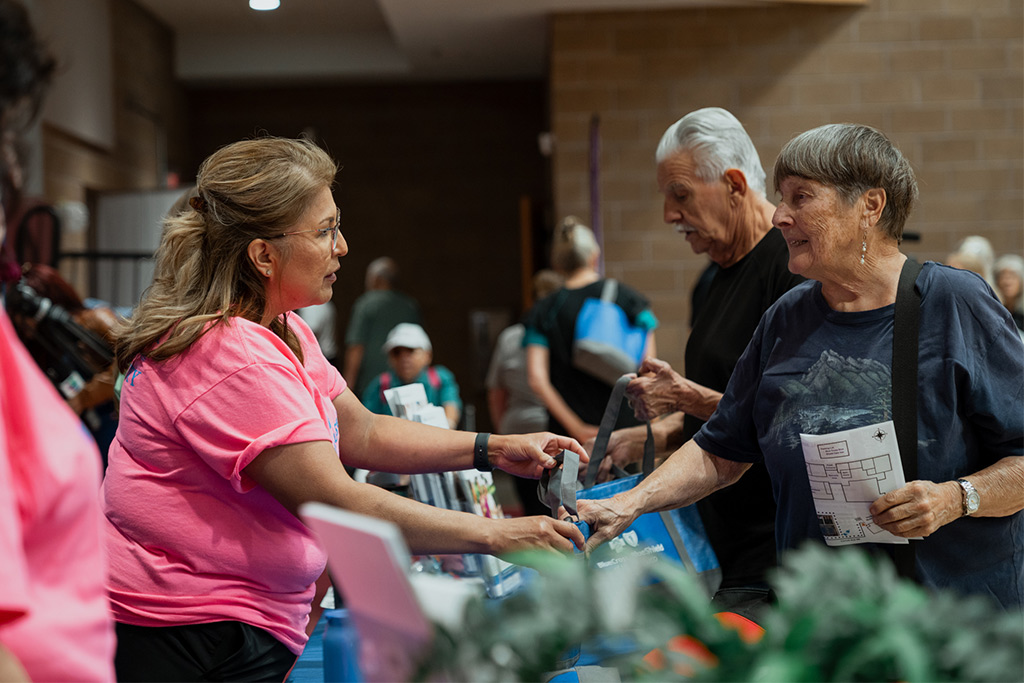 Blue Cross and Blue Shield of New Mexico employee provide information at the Senior Health & Fitness Day