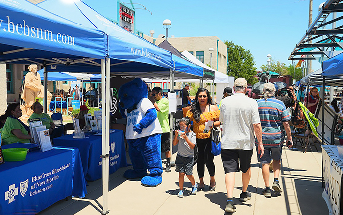 Vendor and partner tents line walkway at Community Health Days outdoor event