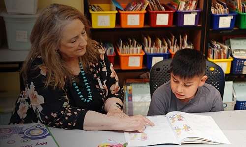 Teacher helps student with his homework