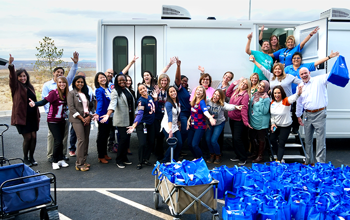 Employee volunteers posing as group at a volunteer event