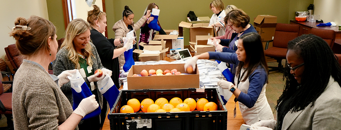 Employee volunteers prepare donation packages